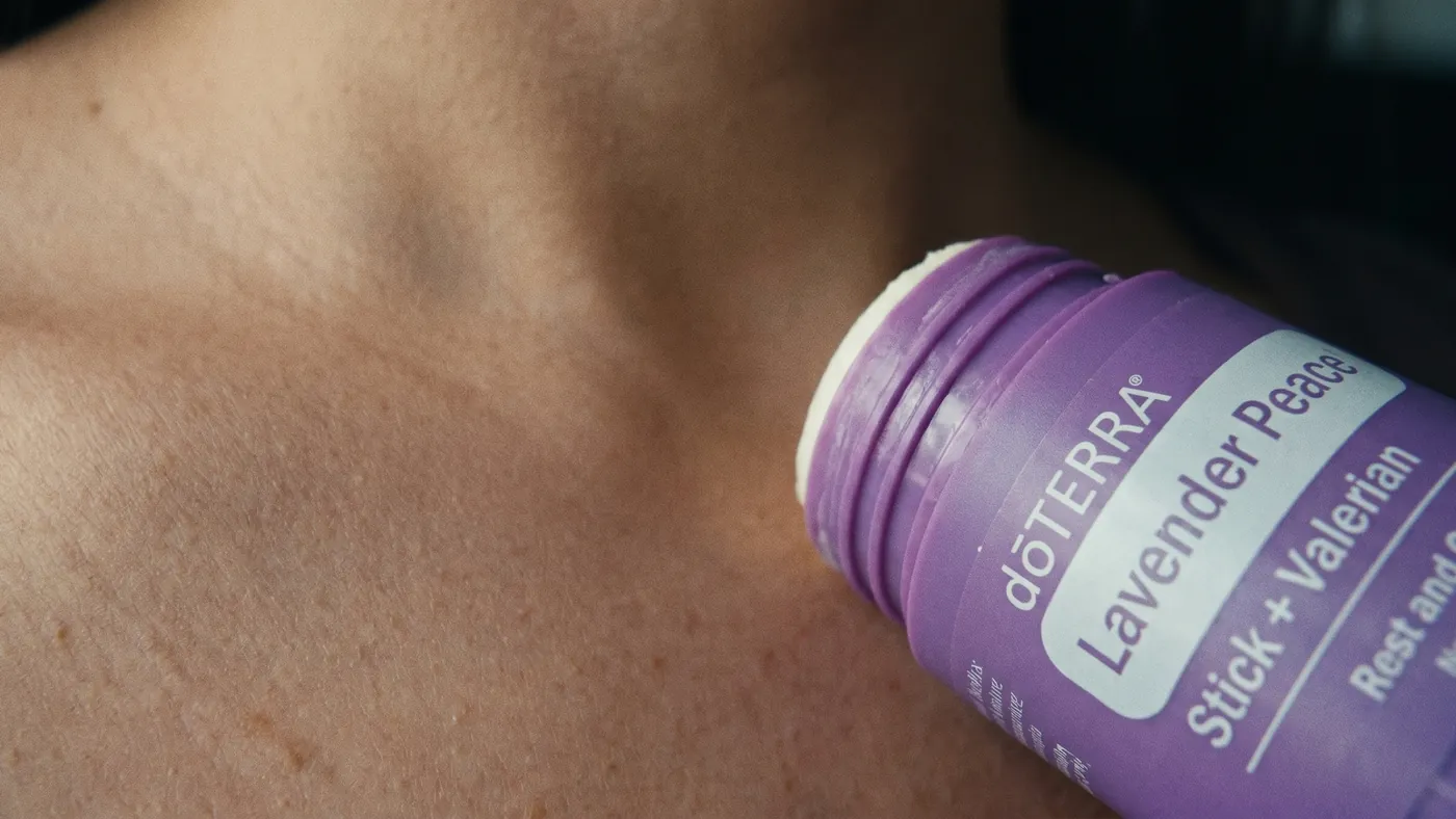 The dōTERRA Lavender Peace Stick + Valerian applied to the upper chest below the collarbone