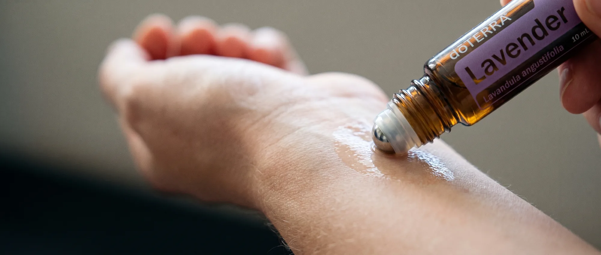 The dōTERRA Lavender roll-on applied to the inside of the wrist, macro close-up