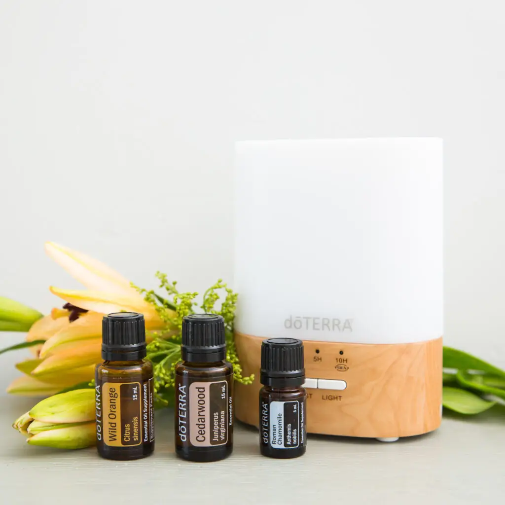 dōTERRA Accessories Range – a stylish Lumo essential oil diffuser with dōTERRA Wild Orange, Cedarwood, and Roman Chamomile oils, perfect for aromatherapy.